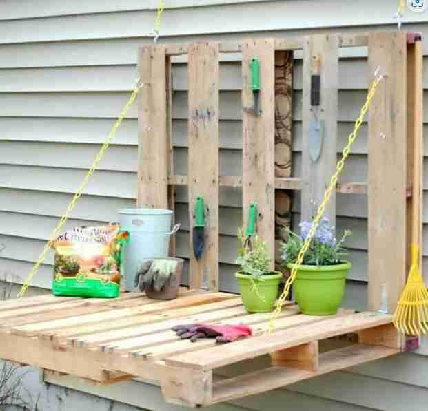 Pallet gardening table with supplies.