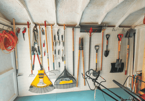 Pegboard garden tool organizer.