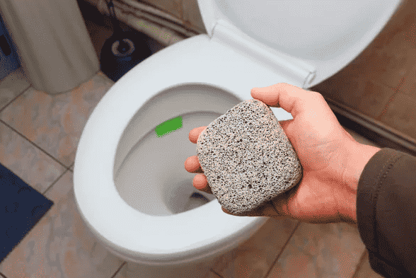 Pumice stone beside toilet.