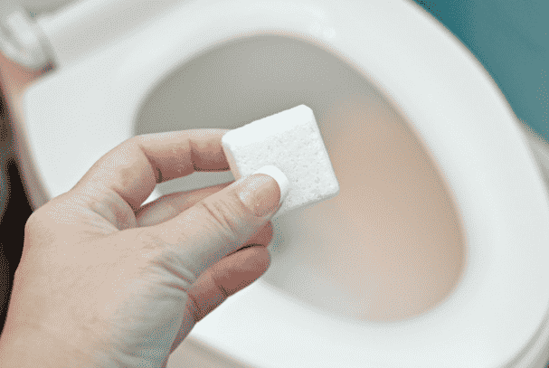 Cleaning bomb going in toilet.