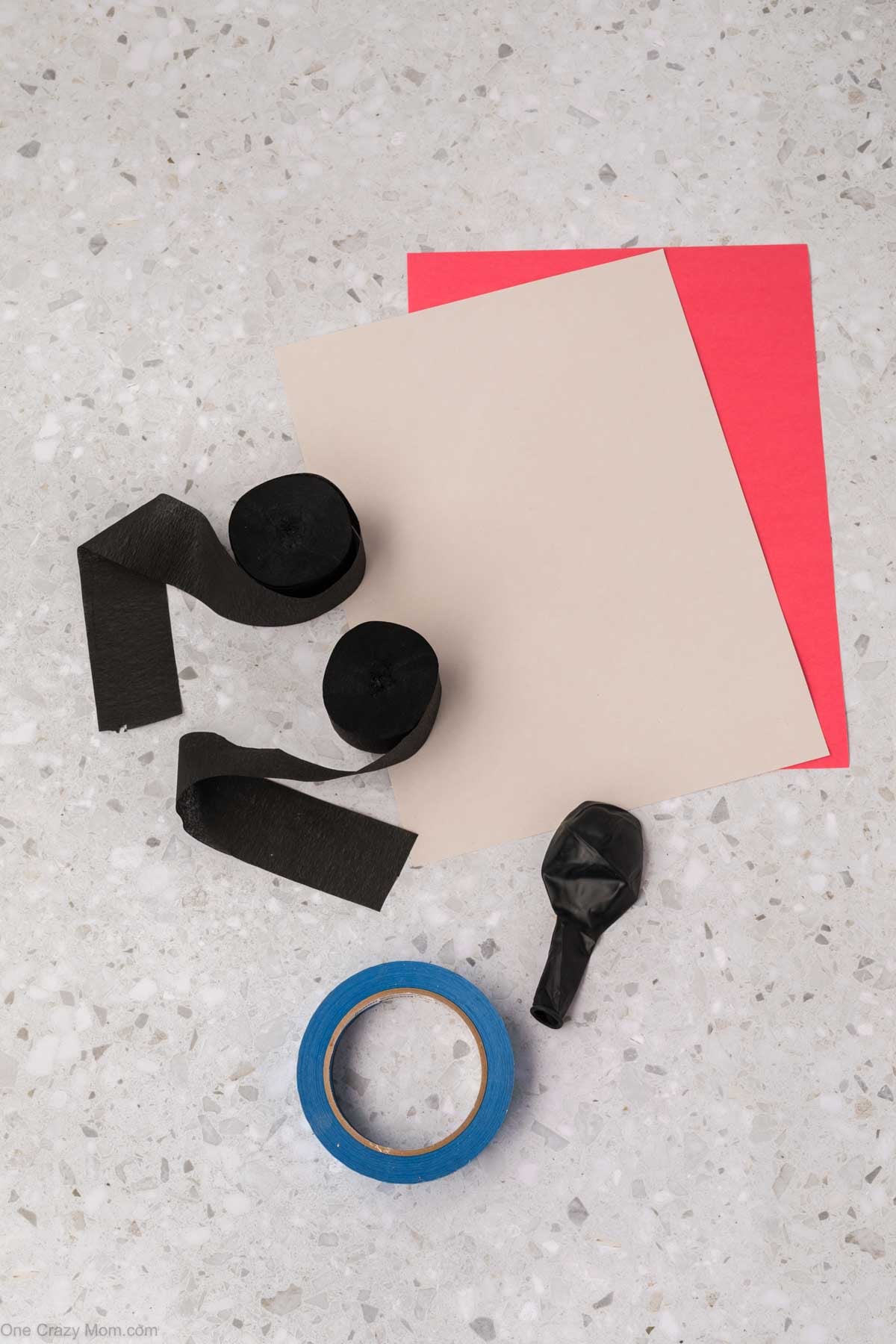 Supplies needed for spider craft - black balloon, crepe paper, painter's tape, red and white construction paper.
