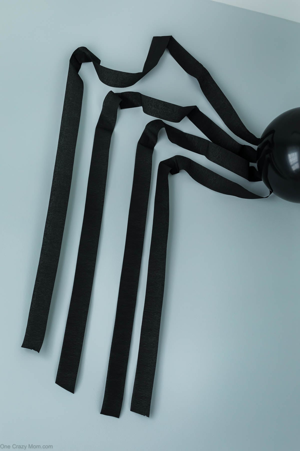 Crepe paper on wall for spider legs.