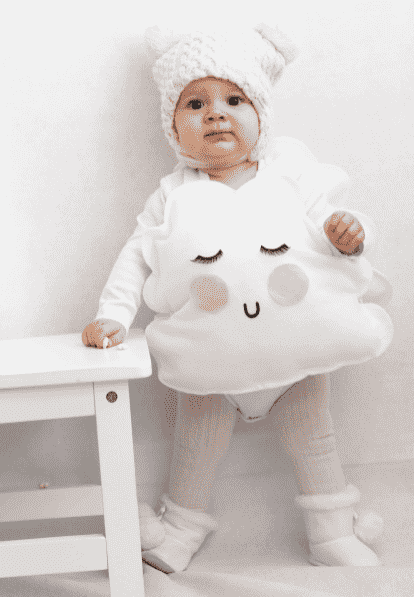 Cloud costume on child standing up.