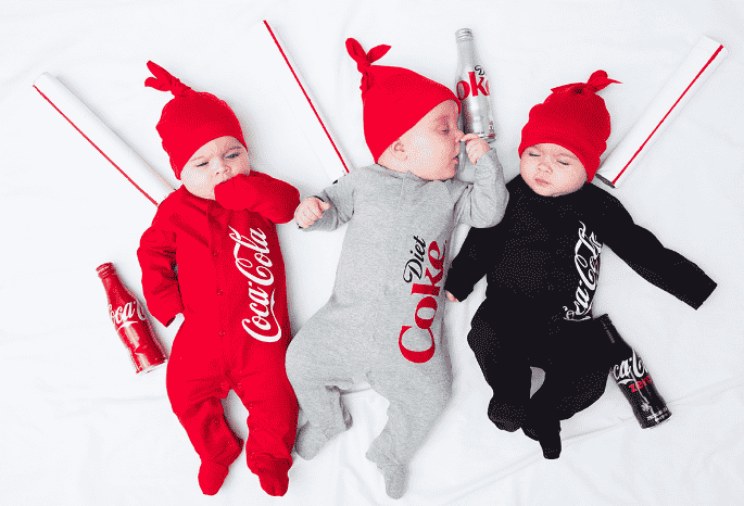 Babies laying down dressed as coke, diet coke and coke zero.