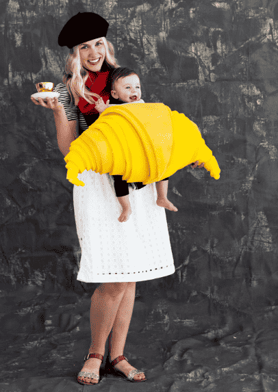 Mom holding a baby dressed as a croissant.