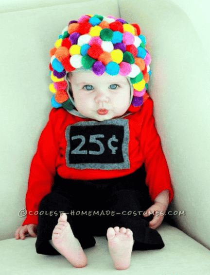 Baby in gumball costume sitting up.