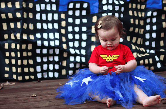 Baby in super hero wonder woman costume.