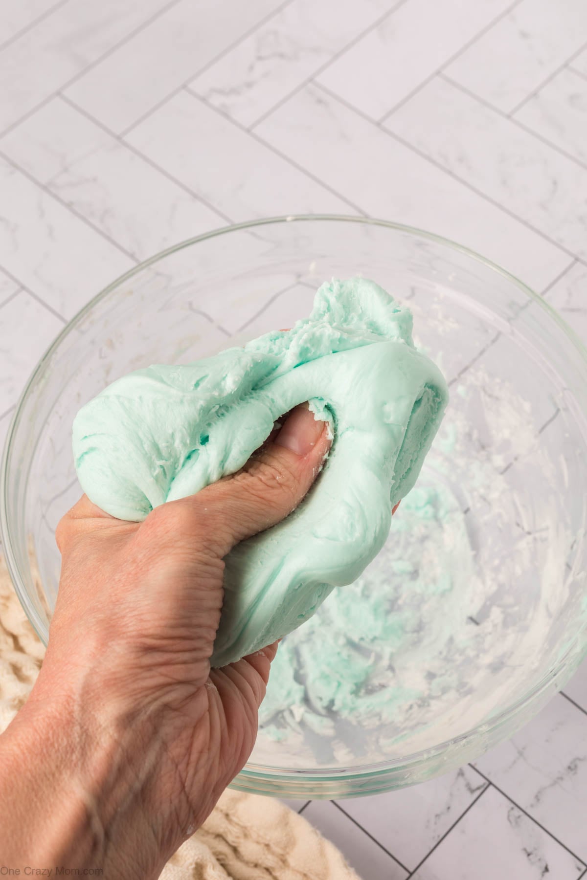Slime being kneaded in hands.