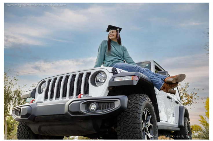Girl on top of jeep.