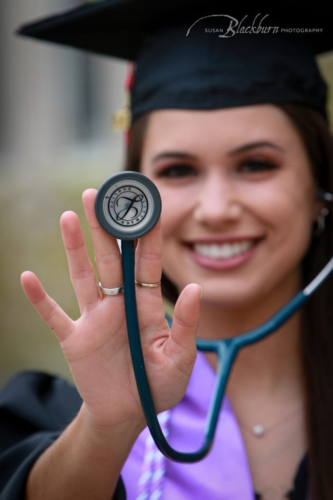 Girl wearing stethoscope.