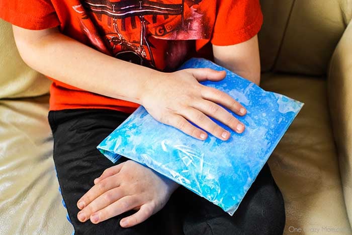 Child with ice pack on arm.