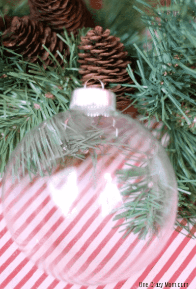 Glass ornament hanging on tree. 
