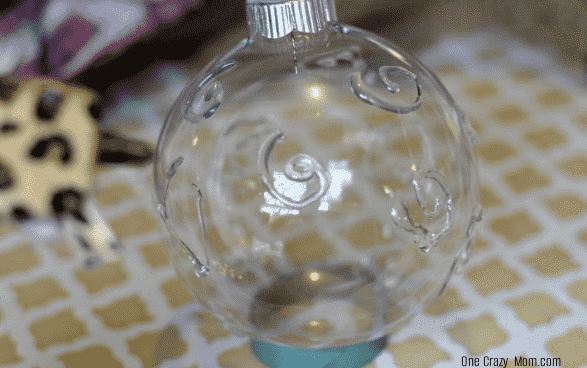 Hot glue on ornament. 