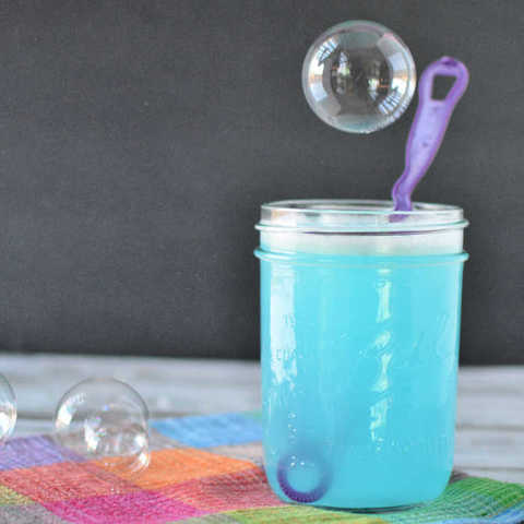 Homemade bubbles solution in a jar.