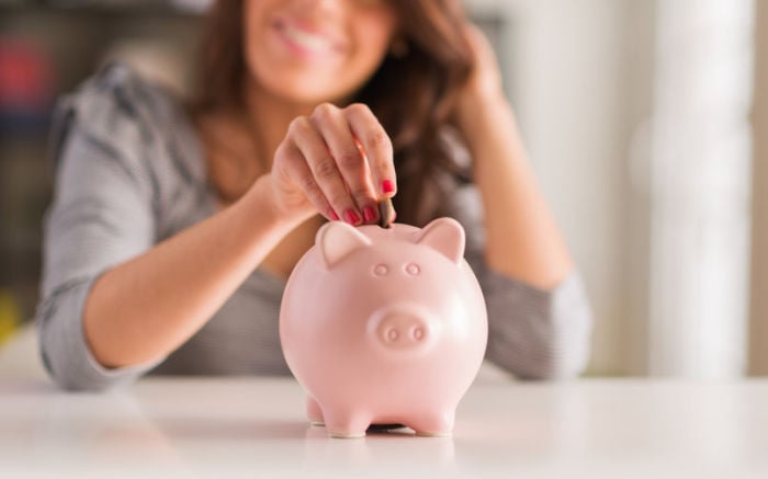 PIggy bank with money going in.