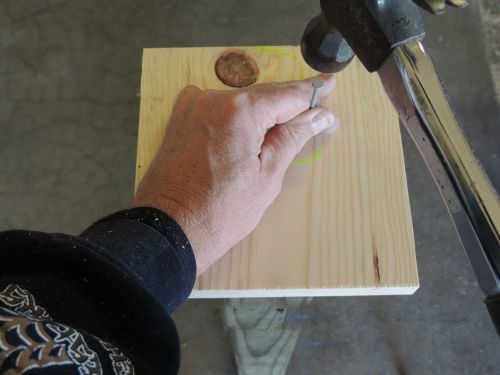 Securing wood with a nail.