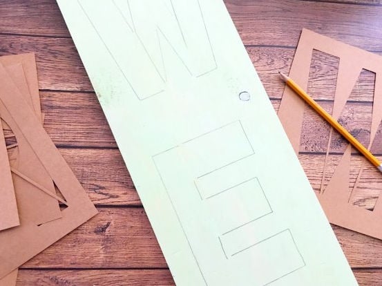 Stenciling the letters.