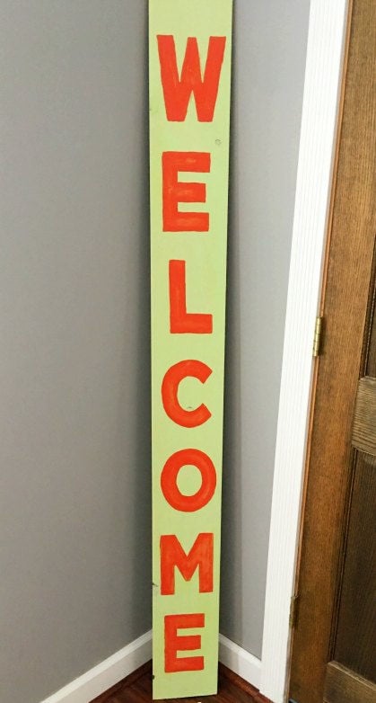 DIY welcome sign on porch.