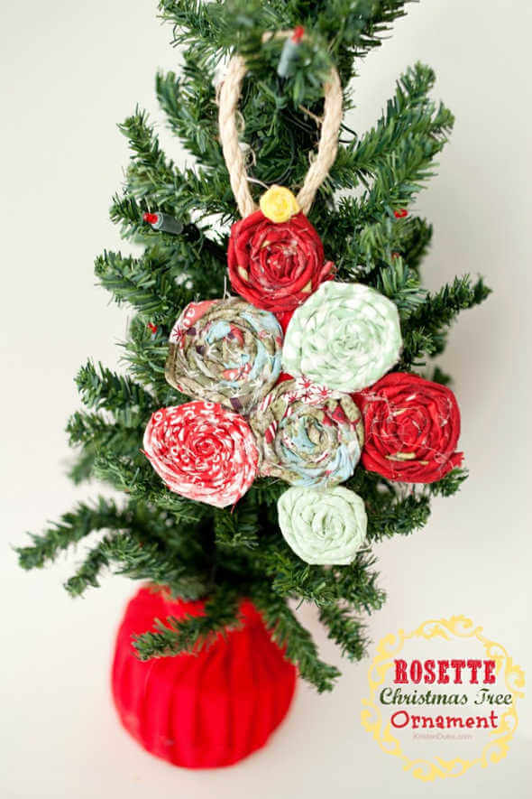 We've rounded up over 30 Easy Homemade Christmas Ornaments. These DIY ornament ideas are simple to make and many use what you already have. Try these fun DIY craft ideas! Your kids will love making these easy handmade ornaments for Christmas! #onecrazymom #christmasornaments #DIYornaments Rosette ornaments in tree.