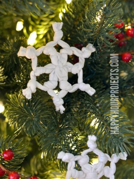 We've rounded up over 30 Easy Homemade Christmas Ornaments. These DIY ornament ideas are simple to make and many use what you already have. Try these fun DIY craft ideas! Your kids will love making these easy handmade ornaments for Christmas! #onecrazymom #christmasornaments #DIYornaments Snowflakes in tree.