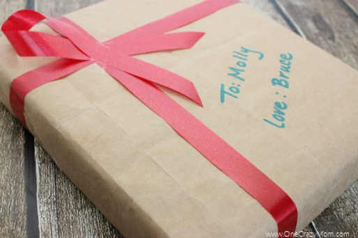 Check out these frugal and creative Christmas gift wrap ideas. Remember, a Christmas gift wrapping idea doesn't have to be hard or expensive. Box wrapped in a brown paper bag and red ribbon.