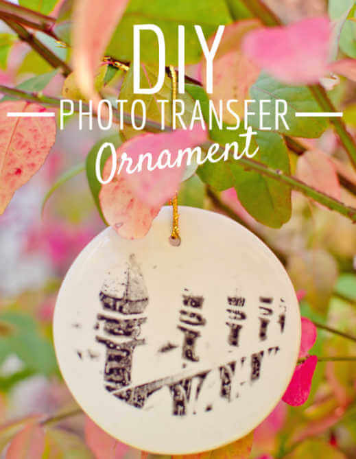We've rounded up over 30 Easy Homemade Christmas Ornaments. These DIY ornament ideas are simple to make and many use what you already have. Try these fun DIY craft ideas! Your kids will love making these easy handmade ornaments for Christmas! #onecrazymom #christmasornaments #DIYornaments Photo transfer ornament hanging.