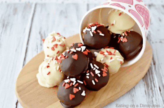 Valentine cake balls on cutting board.