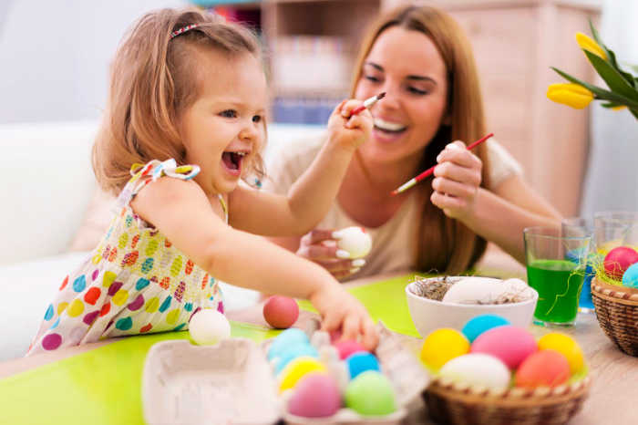 We have 25 Easter egg decorating ideas that are so easy and the kids will love. Gather the family together and make lots of sweet memories with these ideas. Mother and child dying eggs.
