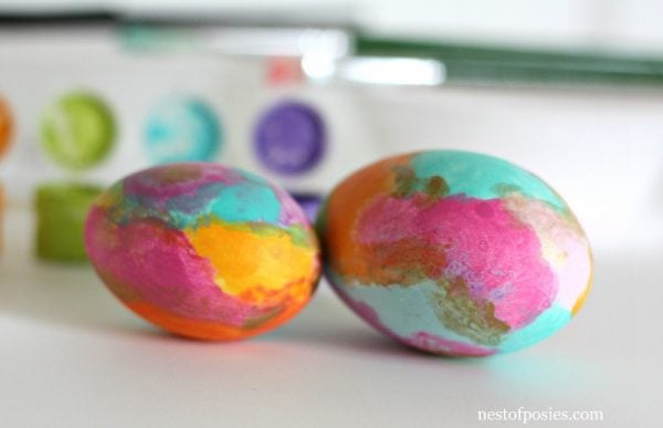 We have 25 Easter egg decorating ideas that are so easy and the kids will love. Gather the family together and make lots of sweet memories with these ideas. Water color eggs sitting on counter.