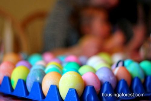 We have 25 Easter egg decorating ideas that are so easy and the kids will love. Gather the family together and make lots of sweet memories with these ideas. Eggs in crate decorated with melted crayons.