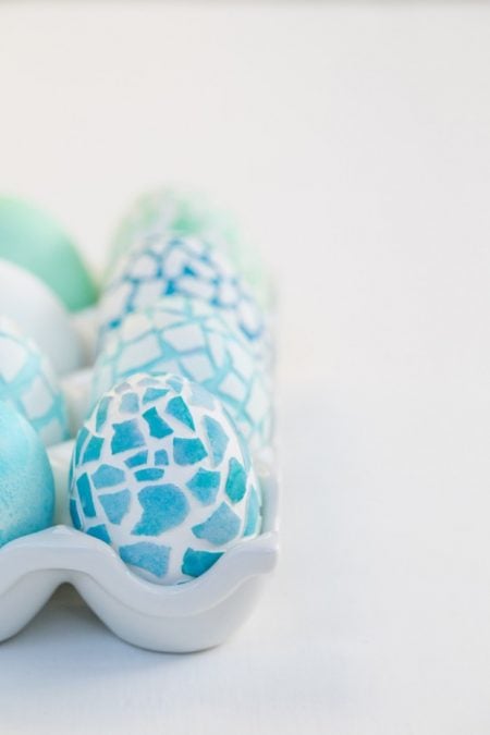We have 25 Easter egg decorating ideas that are so easy and the kids will love. Gather the family together and make lots of sweet memories with these ideas. Mosaic egg with blue and white in carton.