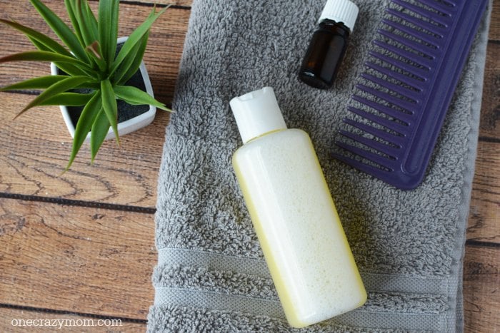 You're going to love this Homemade Dandruff Shampoo. Forget paying way to much at the store when you can make this DIY dandruff shampoo at home. Try it! Shampoo bottle on towel.