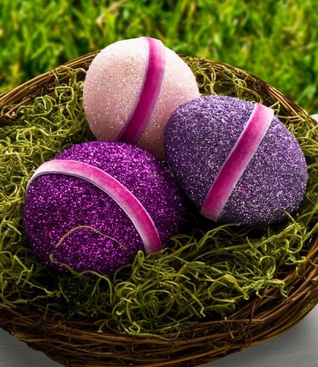 We have 25 Easter egg decorating ideas that are so easy and the kids will love. Gather the family together and make lots of sweet memories with these ideas. Glittered easter eggs in basket with moss.