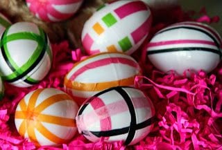 We have 25 Easter egg decorating ideas that are so easy and the kids will love. Gather the family together and make lots of sweet memories with these ideas. Tisue paper eggs on pink easter grass.