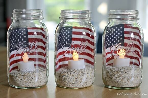 Check out these Fourth of July Crafts. You can make any celebration patriotic with these 4th of July Crafts for your home. DIY mason jar lanterns with a flag.