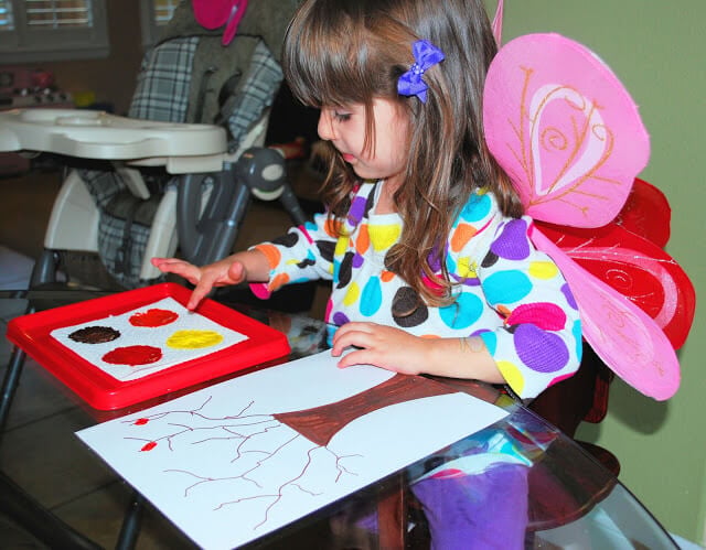 Over 15 of the best Fall Crafts for Kids - Quick and Easy crafts for toddlers - Fall Crafts for toddlers and more. Easy DIY fall crafts everyone will love! #onecrazymom #craftideas #kidscrafts #fall Child making fingerprint tree.