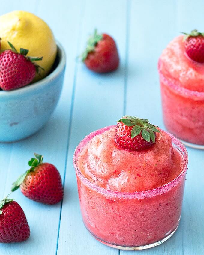 There is nothing like a cold drink in the summer. Whip up these kid friendly frozen drink recipes for a fun way to beat the heat. They are quick and easy! Strawberry Slushie in a glass.