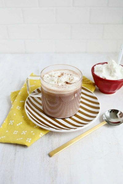Try these easy hot chocolate recipes for an amazing treat everyone will love this Winter. 20 of the best hot cocoa recipes. You will love these homemade hot chocolate recipes that are made in the crock pot, some with cocoa powder. Learn how to make your own hot chocolate at home! #eatingonadime #hotchocolaterecipes #drinkrecipes #winterrecipes nutella hot chocolate in a clear glass.