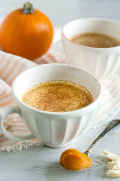 Try these easy hot chocolate recipes for an amazing treat everyone will love this Winter. 20 of the best hot cocoa recipes. You will love these homemade hot chocolate recipes that are made in the crock pot, some with cocoa powder. Learn how to make your own hot chocolate at home! #eatingonadime #hotchocolaterecipes #drinkrecipes #winterrecipes Pumpkin white hot chocolate in a white mug.