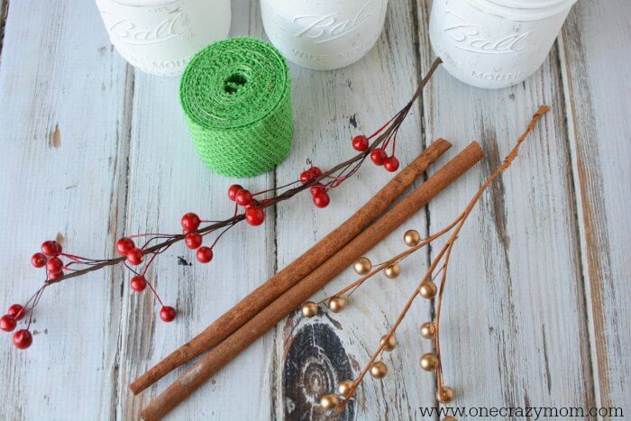 If you're looking for holiday centerpiece ideas,make this rustic Christmas centerpiece.This mason jar Christmas centerpiece is so simple and easy! Ribbon and cinnamon sticks needed for this centerpiece.