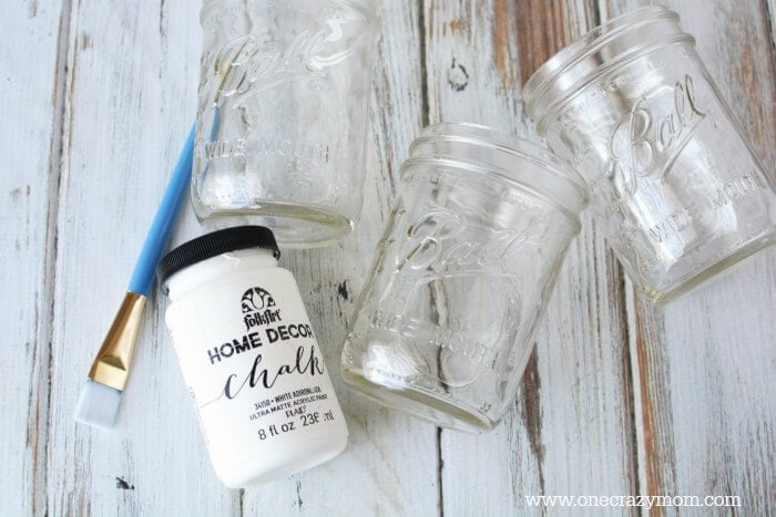 If you're looking for holiday centerpiece ideas,make this rustic Christmas centerpiece.This mason jar Christmas centerpiece is so simple and easy! Jars, paint and paint brushes needed for DIY.