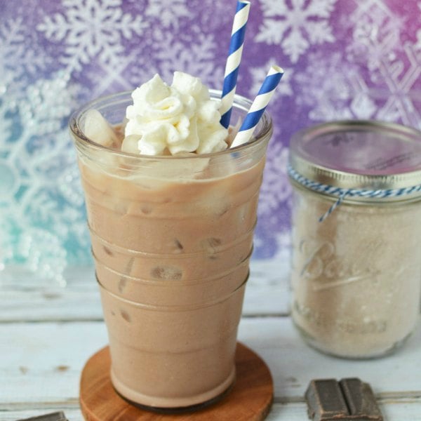 Try these easy hot chocolate recipes for an amazing treat everyone will love this Winter. 20 of the best hot cocoa recipes. You will love these homemade hot chocolate recipes that are made in the crock pot, some with cocoa powder. Learn how to make your own hot chocolate at home! #eatingonadime #hotchocolaterecipes #drinkrecipes #winterrecipes Iced hot chocolate in a cup sitting on a coaster.