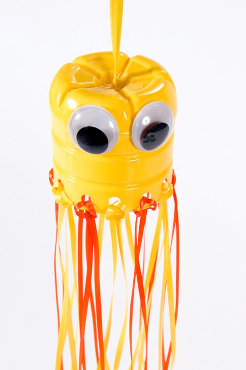I think you will love these water bottle crafts for kids. These are perfect for keeping the kids busy without breaking the bank! Try 12 water bottle crafts for kids recycled. Your kids are going to love these DIY plastic bottle crafts! #onecrazymom #crafts #craftideas Hanging jellyfish using a water bottle.