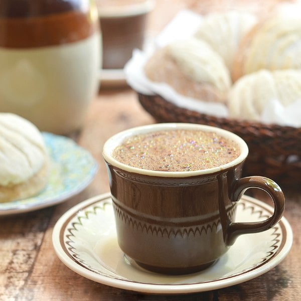 Try these easy hot chocolate recipes for an amazing treat everyone will love this Winter. 20 of the best hot cocoa recipes. You will love these homemade hot chocolate recipes that are made in the crock pot, some with cocoa powder. Learn how to make your own hot chocolate at home! #eatingonadime #hotchocolaterecipes #drinkrecipes #winterrecipes Mexican hot chocolate in a brown mug sitting on a saucer.