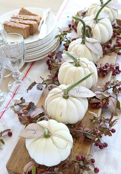Make your table beautiful with these easy Thanksgiving table decor ideas. 20 Thanksgiving table decorating ideas that are budget friendly and easy to make. White pumpkins with leaves and twine on the table.