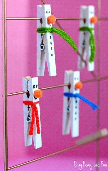 Find Easy Christmas Crafts for kids that are easy to do. They will love these Christmas crafts for kids. 20 Christmas craft ideas for kids that are frugal and great for gifts or ornaments. These fun projects are great for toddlers and older kids too. Perfect for school or for Christmas decorations! #onecrazymom #christmascrafts #kidcrafts Clothespin Snowman clipped on wire.