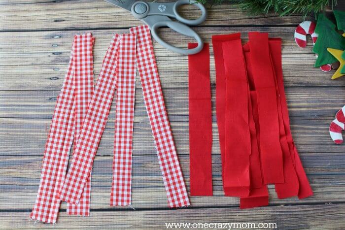 Garland makes your home festive for Christmas. DIY Christmas garland is perfect for the mantle or anywhere you need a festive touch. It's so easy to make! Strips of fabric separate by color.