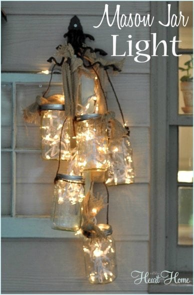 Get your home ready for Christmas with these 25 Christmas Porch Decorating Ideas. Beautiful Christmas porch ideas that are simple and budget friendly! Mason jar light with bow.