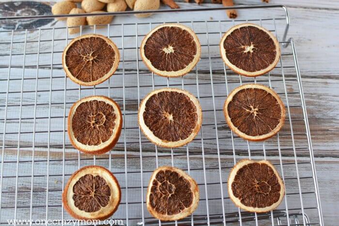Learn how to make homemade Christmas Potpourri that smells amazing. It is so easy! Find out how to make potpourri with very little effort or expense. Dried oranges on wire rack.