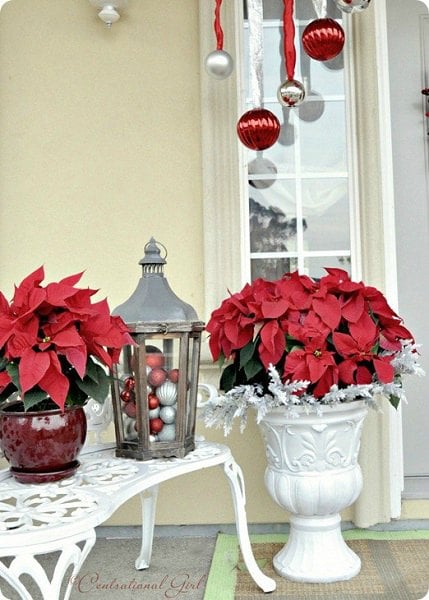 Get your home ready for Christmas with these 25 Christmas Porch Decorating Ideas. Beautiful Christmas porch ideas that are simple and budget friendly! Decorative urns and lantern.